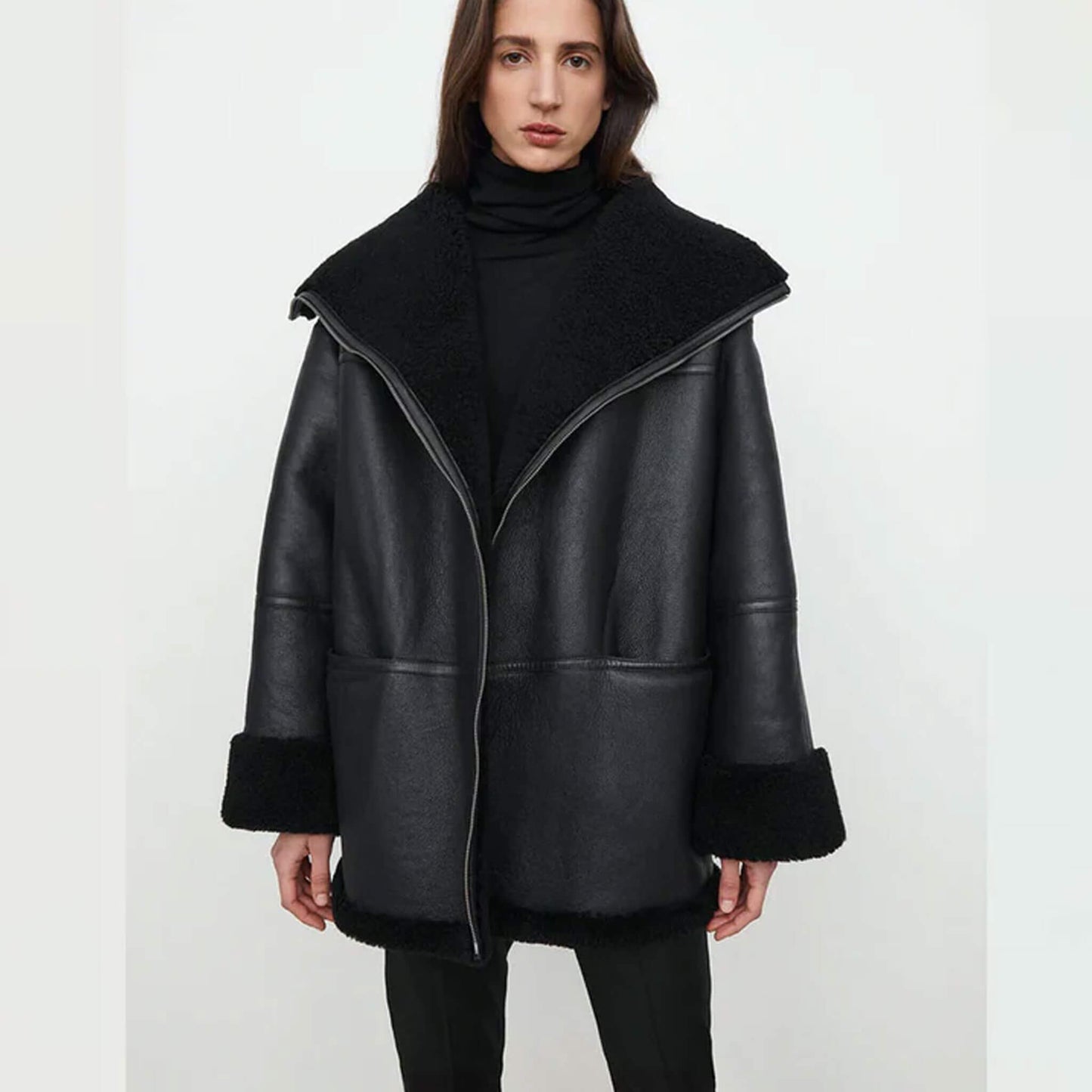 Midnight Luxe Shearling Jacket crafted from premium goatskin leather with faux fur lining, featuring a relaxed fit, wide lapel collar, folded cuffs, and oversized winter coat silhouette in elegant black – stylish shearling jacket for women’s winter fashion.