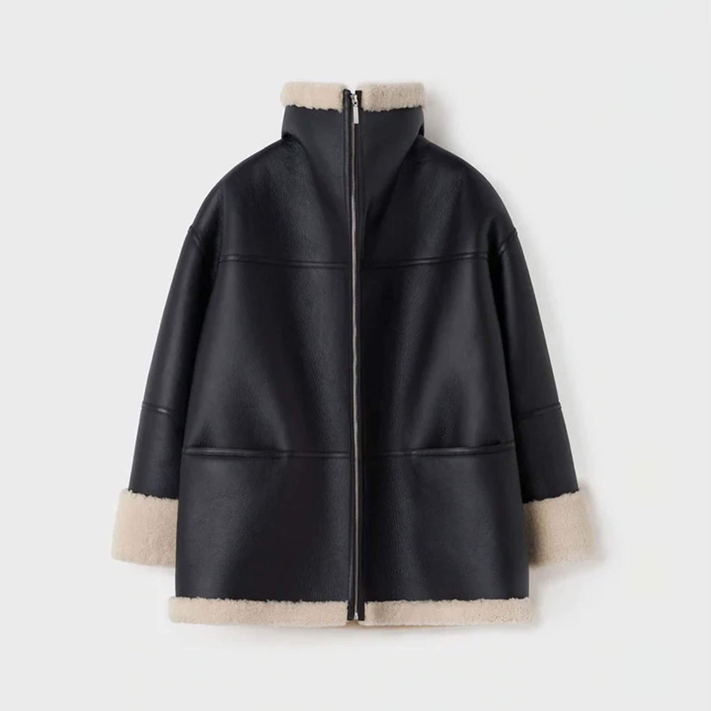 Back ghost mannequin view of a women’s oversized shearling leather jacket made from goatskin leather with faux shearling lining. The oversized design and panel stitching stand out, paired with cream shearling trim at the hem and cuffs. This view showcases the jacket’s craftsmanship and durability, offering customers a clear look at this oversized shearling winter coat’s back detailing.