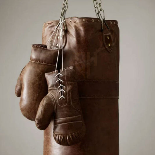 Front view of Burnt Brown Leather Heavy Punching Bag crafted from premium natural cowhide leather. Durable and reinforced stitching ensures long-lasting use. Perfect for home gym, boxing training, MMA workouts, and Muay Thai. Heavy-duty leather punching bag with stainless steel hanging chain, ideal for intense fitness and combat sports training.
