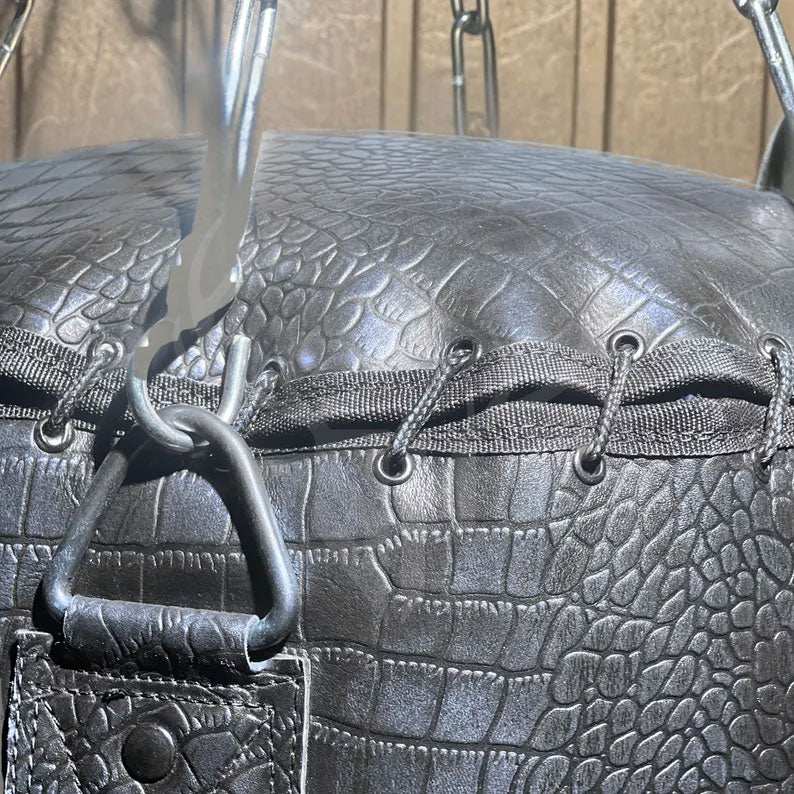 Close-up of the lace-up closure at the top of the Azure Mauler punching bag, showing strong, reinforced cowhide panels stitched securely and tied with durable leather lacing. The traditional lace-top design allows easy access for filling while maintaining the premium aesthetic and secure construction ideal for boxing and MMA training setups.