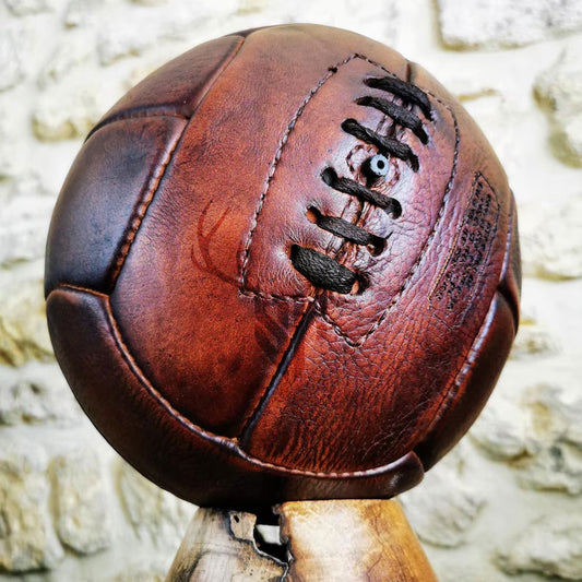 Retro 1930s-style American football in tan cowhide leather, handmade and customizable for play, gift, or vintage home decor.