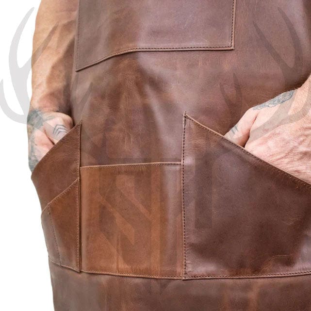 Close-up view of the ForgeWear Rustic Leather Work Apron’s pocket layout, featuring a large central front pocket (27.5cm x 18.5cm), a bottom central pocket (17.5cm x 13cm), and six smaller tool pockets arranged for brushes, pens, and accessories. Designed for maximum utility and quick access, the pockets are stitched into the full-grain distressed leather for durability—perfect for professional use in