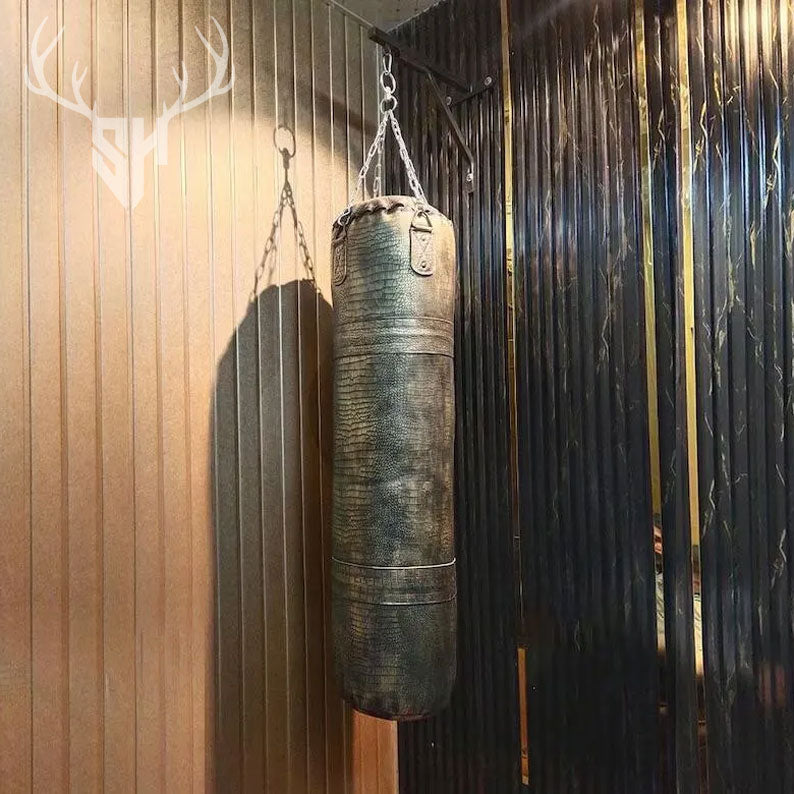 Golden Croc Leather Heavy Punching Bag hanging in a stylish home gym. Made from genuine crocodile-embossed cowhide leather, perfect for boxing, MMA, and fitness workouts.