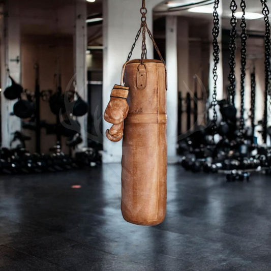 The Gravestone Heritage Leather Punching Bag shown in a modern training studio setup, emphasizing its dual function as a high-performance workout tool and eye-catching gym decor. Ideal for boxing, MMA, and fitness enthusiasts looking for authentic training gear with a vintage twist.