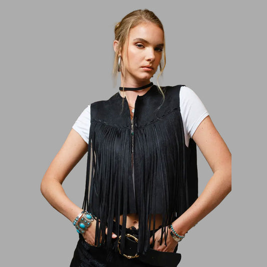 Woman wearing the Onyx Black suede fringe vest at a music festival, pairing bold western vibes with comfort and edgy fashion appeal.