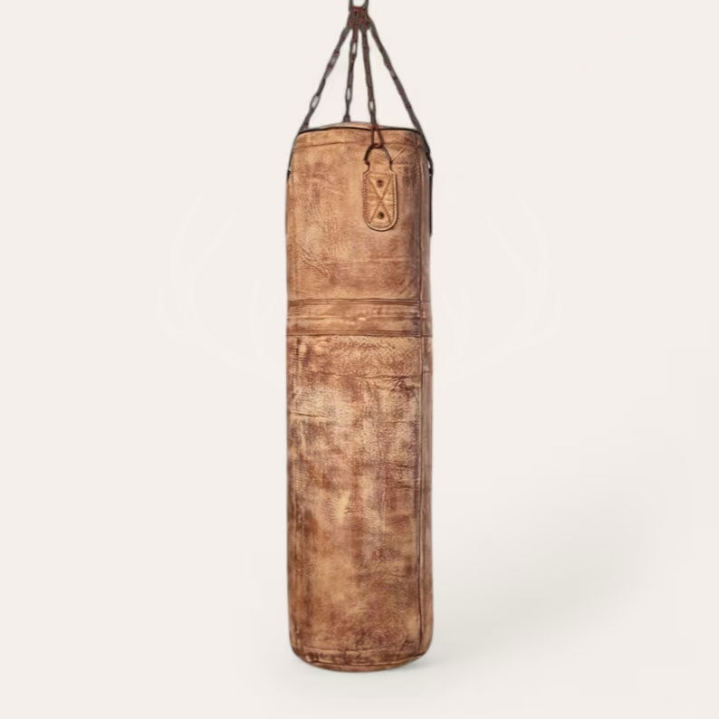 Showcasing the Gravestone Heritage Punching Bag’s full-grain cowhide construction and durable steel chains, this side view captures the sturdy hanging mechanism and bag’s premium leather texture. Designed for intense workouts and professional-grade usage in combat sports and conditioning drills.