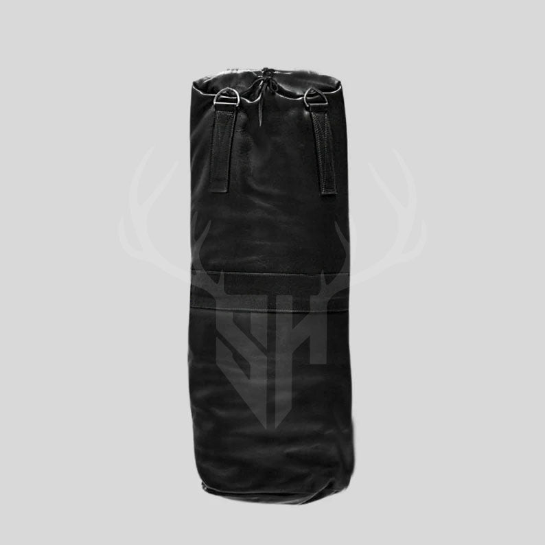 Staghide Black Buffalo Striker heavy bag hanging by stainless steel chains in a gym setting. Made from 100% real cowhide leather, this boxing and MMA punching bag offers realistic movement, reinforced construction, and classic gym aesthetics. Perfect for fighters and fitness enthusiasts focused on strength, endurance, and professional combat training.