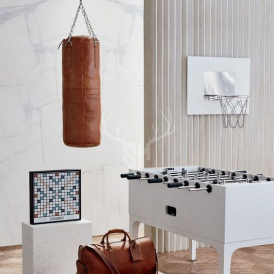 Rear view of Sundown Tan Leather Heavy Punching Bag showing its smooth cowhide leather surface and solid construction. Heavy-duty stitching and sturdy hanging chain ensure durability and secure placement in any gym or training environment.