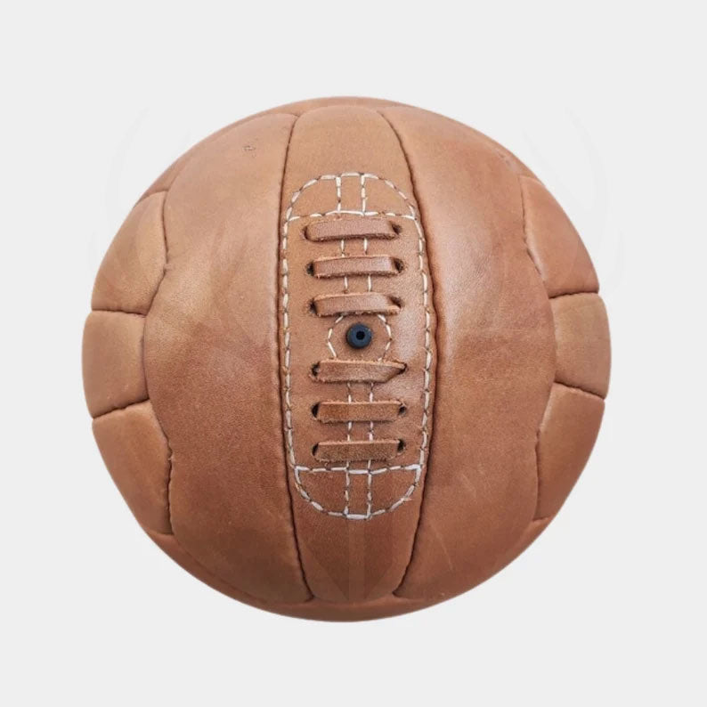 Decorative image of the 1934 Federale 102 replica soccer ball placed on a wooden shelf or office desk setup, styled for vintage sports decor, football-themed interiors, or man cave accessories.

