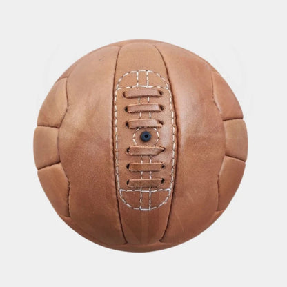 Decorative image of the 1934 Federale 102 replica soccer ball placed on a wooden shelf or office desk setup, styled for vintage sports decor, football-themed interiors, or man cave accessories.

