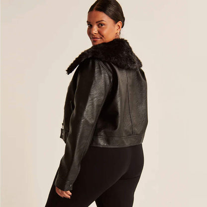 Lynora Black Shearling Biker Jacket side view – Cropped biker-style leather jacket with black faux shearling collar and lining, silver zippers, and waist adjusters. A stylish and warm women’s winter shearling outerwear.