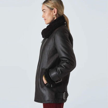 Luxury women’s shearling leather jacket in black, designed with a bold asymmetrical zip and plush shearling lining for warmth. Wide shearling lapel adds a touch of chic elegance, while genuine leather ensures durability and timeless style. Perfect for cold-weather outfits, this versatile jacket blends comfort with fashion, making it an essential piece for women who appreciate premium quality and stylish winter wear.