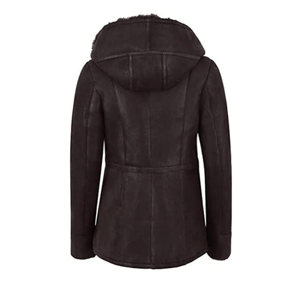 Chic black shearling leather jacket for women, featuring a cozy fur hood and warm shearling lining for superior winter protection. Crafted from real leather, this jacket combines durability with elegant design. Zippered pockets and a fitted silhouette enhance practicality and style, making it a perfect addition to women’s winter fashion wardrobes. A timeless outerwear choice for modern women who value luxury and function.
