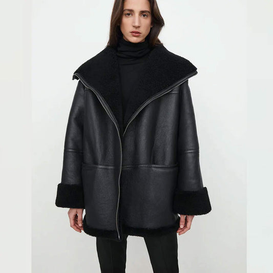 Midnight Luxe Shearling Jacket crafted from premium goatskin leather with faux fur lining, featuring a relaxed fit, wide lapel collar, folded cuffs, and oversized winter coat silhouette in elegant black – stylish shearling jacket for women’s winter fashion.