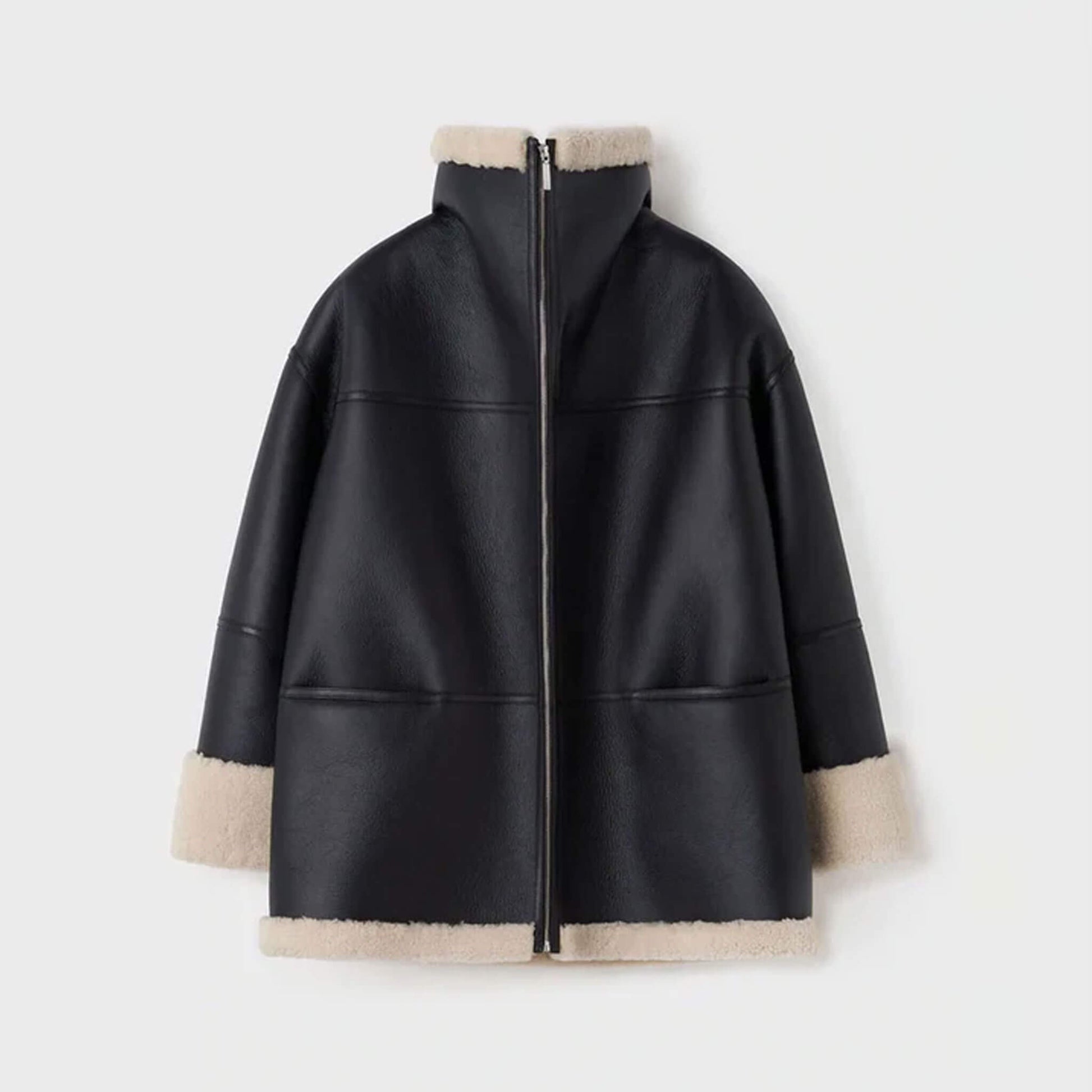 Back ghost mannequin view of a women’s oversized shearling leather jacket made from goatskin leather with faux shearling lining. The oversized design and panel stitching stand out, paired with cream shearling trim at the hem and cuffs. This view showcases the jacket’s craftsmanship and durability, offering customers a clear look at this oversized shearling winter coat’s back detailing.