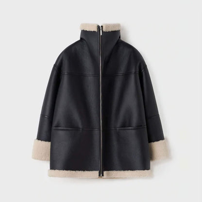 Back ghost mannequin view of a women’s oversized shearling leather jacket made from goatskin leather with faux shearling lining. The oversized design and panel stitching stand out, paired with cream shearling trim at the hem and cuffs. This view showcases the jacket’s craftsmanship and durability, offering customers a clear look at this oversized shearling winter coat’s back detailing.