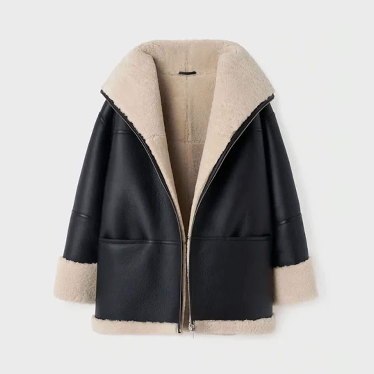 Front ghost mannequin display of an oversized women’s shearling leather jacket in black goatskin leather with faux fur lining. The oversized silhouette, shearling collar, and turned-up cuffs are clearly shown, emphasizing its warm and cozy construction. Ideal for highlighting the product’s structure, material quality, and luxurious oversized winter shearling coat appeal.