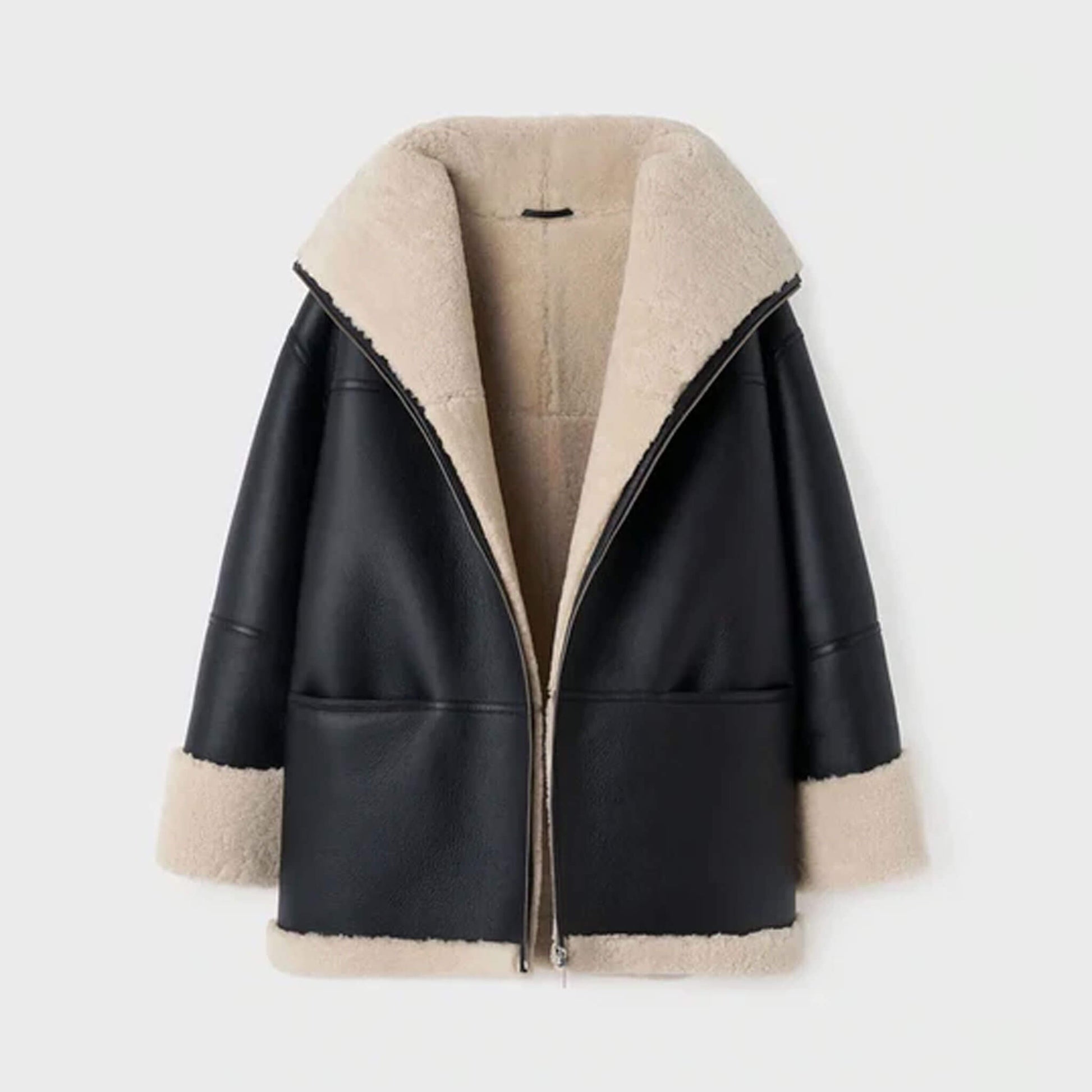 Front ghost mannequin display of an oversized women’s shearling leather jacket in black goatskin leather with faux fur lining. The oversized silhouette, shearling collar, and turned-up cuffs are clearly shown, emphasizing its warm and cozy construction. Ideal for highlighting the product’s structure, material quality, and luxurious oversized winter shearling coat appeal.