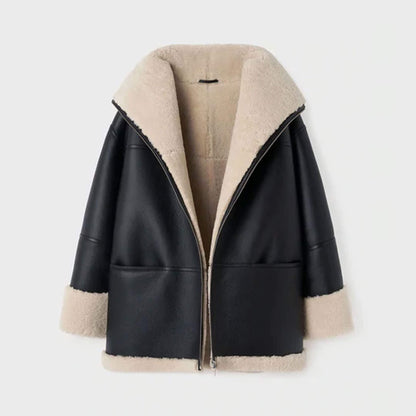 Front ghost mannequin display of an oversized women’s shearling leather jacket in black goatskin leather with faux fur lining. The oversized silhouette, shearling collar, and turned-up cuffs are clearly shown, emphasizing its warm and cozy construction. Ideal for highlighting the product’s structure, material quality, and luxurious oversized winter shearling coat appeal.