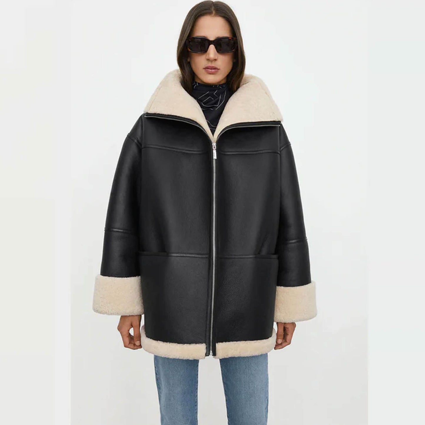 A stylish women’s oversized shearling jacket crafted from premium goatskin leather, featuring a black exterior with soft faux shearling lining. The front view shows the relaxed fit, wide collar, and turned-up cuffs, highlighting its cozy oversized winter style. Perfect for women seeking a chic oversized leather shearling coat for casual and streetwear looks.