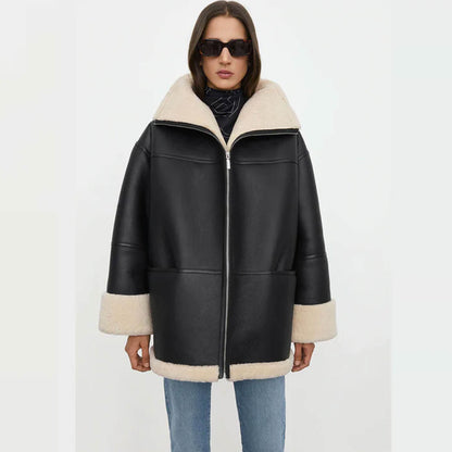 A stylish women’s oversized shearling jacket crafted from premium goatskin leather, featuring a black exterior with soft faux shearling lining. The front view shows the relaxed fit, wide collar, and turned-up cuffs, highlighting its cozy oversized winter style. Perfect for women seeking a chic oversized leather shearling coat for casual and streetwear looks.
