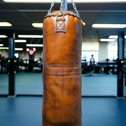 Close-up view of premium reinforced hand-stitching on the Vintage Titan Tan Leather Punching Bag, showing durable craftsmanship and heavy-duty cowhide leather perfect for long-lasting use in boxing and MMA training.