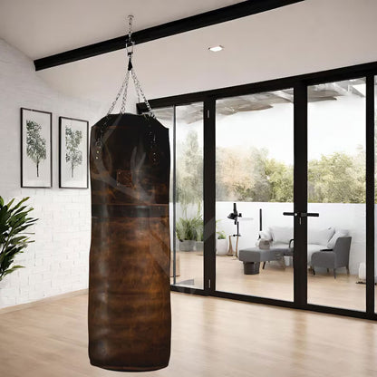 Detailed close-up of the cowhide leather punching bag’s grain, hand-stitching, and chain attachment point. Highlights premium craftsmanship and rugged performance built into the Legacy Striker heavy bag.

