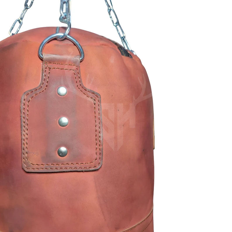 Detailed close-up of the heavy-duty stainless steel hanging chain and secure fasteners attached to the Striker Uppercut Leather Punching Bag, demonstrating the premium hardware quality built to withstand rigorous training sessions.

