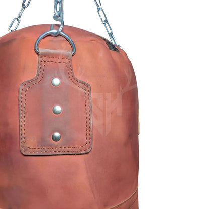 Detailed close-up of the heavy-duty stainless steel hanging chain and secure fasteners attached to the Striker Uppercut Leather Punching Bag, demonstrating the premium hardware quality built to withstand rigorous training sessions.

