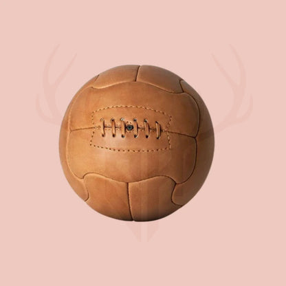 Extreme close-up of rich textured cowhide leather and stitching on 1950 Duplo T replica football, showcasing high-end craftsmanship, vintage feel, and collectible soccer design.

