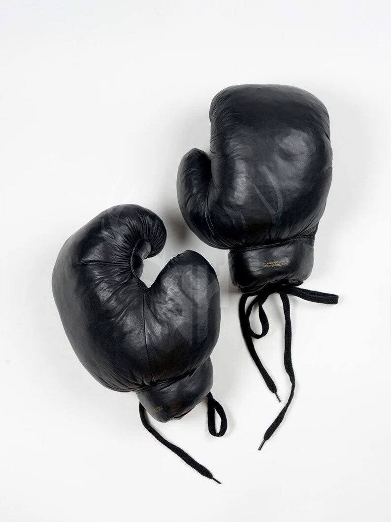 Handcrafted retro-style black leather boxing gloves made from premium cowhide, featuring natural fiber padding and vintage lace-up system. Designed for boxing, MMA, and kickboxing training with a classic, professional look. Personalization available for initials or logos.

