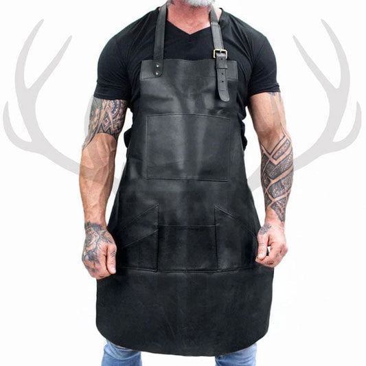 ForgeWear Deep Black Leather Work Apron made from distressed full-grain leather, displayed flat to showcase all front pockets, adjustable straps, and antique brass hardware—ideal for barbers, chefs, artisans, and blacksmiths who require stylish, functional workwear.


