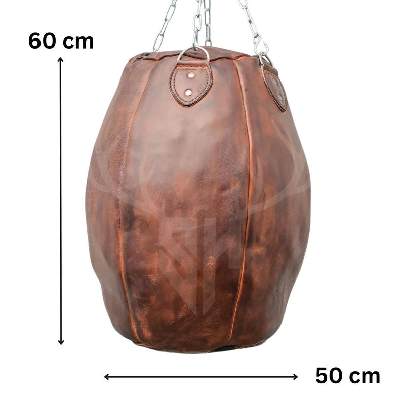 The Brutestone Leather Wrecking Ball Punching Bag displayed next to a size reference chart, showing its 50cm width, 60cm height, and 50cm depth. This 45 KG (100 lbs) compact yet heavy bag is ideal for home gyms and professional setups, providing pro-level resistance and an authentic training feel in a manageable size.

