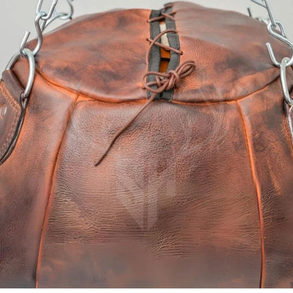 Close-up of the premium cowhide surface and leather-laced lid of the Brutestone Wrecking Ball Bag. Showcases the artisan-level detailing, deep texture, and strength of the hand-stitched leather. Designed to endure hard hits and replicate real combat resistance, making it a top-tier choice for uppercut training in boxing and martial arts.

