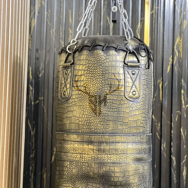 Close-up view of crocodile-embossed cowhide leather texture on Golden Croc Leather Heavy Punching Bag. Showcases rugged, durable design with hand-stitched reinforcement for intensive training.