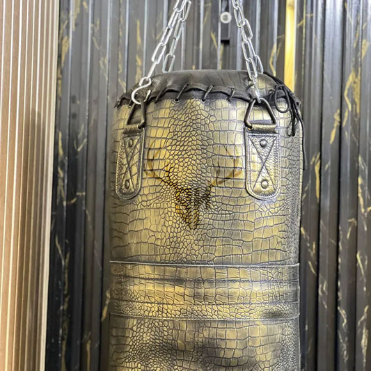 Close-up view of crocodile-embossed cowhide leather texture on Golden Croc Leather Heavy Punching Bag. Showcases rugged, durable design with hand-stitched reinforcement for intensive training.