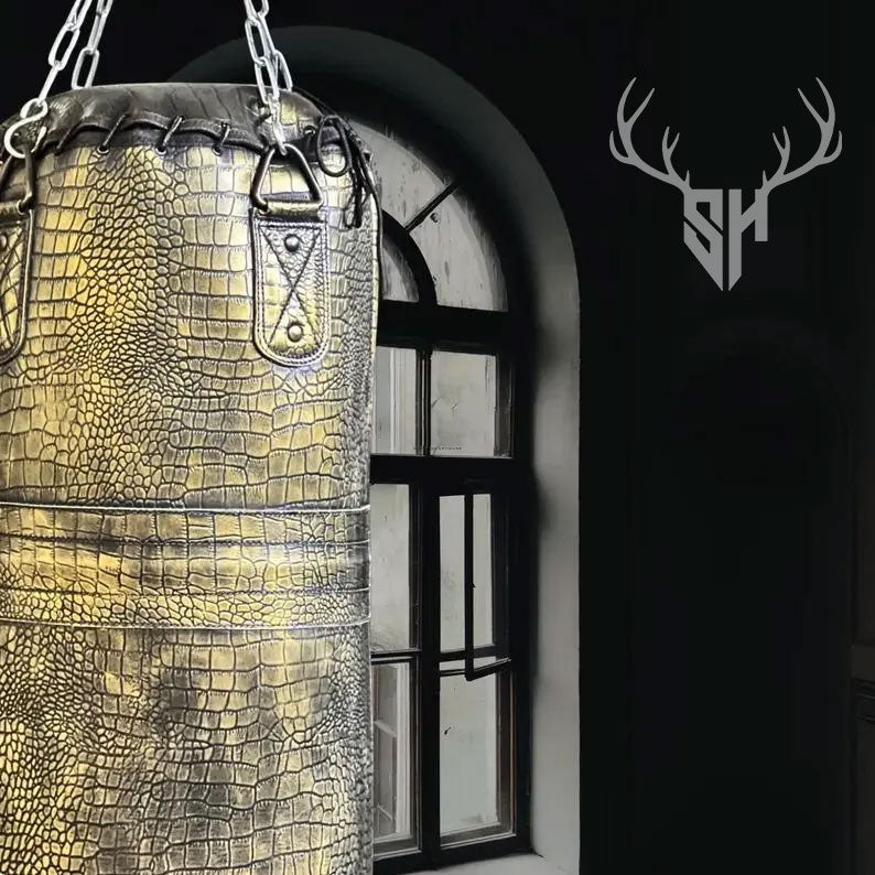 Weight specifications of Golden Croc Leather Heavy Punching Bag for different sizes: 3ft (25kg), 4ft (32kg), 5ft (42kg), and 6ft (52kg). Unfilled bag for custom weight filling.