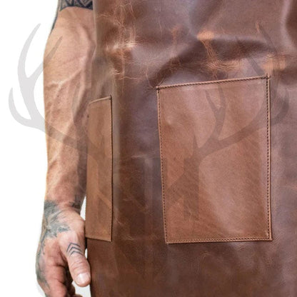 Close-up view of the dual front pockets on the Stonewood Artisan Leather Apron, handcrafted from rustic brown full-grain leather. Each pocket measures 18cm by 14cm and is reinforced with durable stitching to withstand regular use. Ideal for holding hand tools, brushes, kitchen utensils, or accessories, the pockets offer both style and function—perfect for chefs, woodworkers, artists, and craftsmen.
