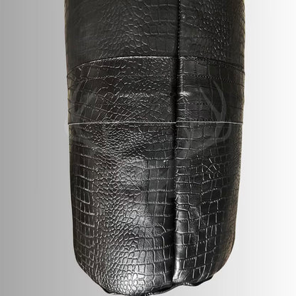 Close-up image showing the detailed crocodile-embossed black leather texture of the Onyx Croc Punching Bag, crafted from full-grain cowhide, capturing the rich surface grain and premium finish.
