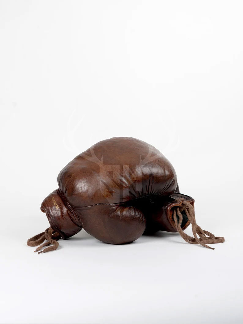 Side angle of Staghide Retro Vintage Brown Leather Boxing Gloves showcasing handcrafted design, natural fiber padding, and classic lacing system for superior fit and comfort.