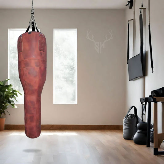 Close-up of the Striker Uppercut Leather Punching Bag showcasing its inclined uppercut design and premium full-grain cowhide leather. The handcrafted reinforced stitching and natural leather grain highlight the bag’s durability and professional-grade quality, perfect for boxing, MMA, and martial arts training enthusiasts looking for high-performance equipment.

