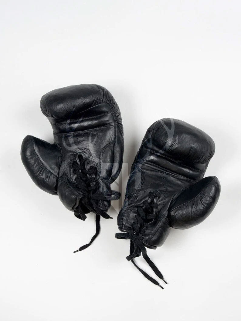 Vintage black leather boxing gloves with classic lace-up design displayed on a white background. Ideal for ecommerce and promotional display for fighters and collectors.

